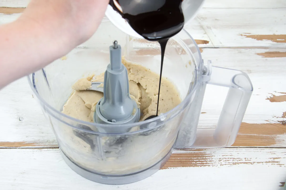 pouring chocolate sauce on banana ice cream