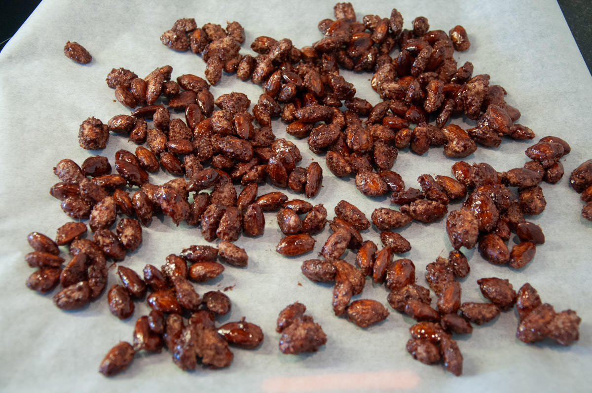 candied almonds an a baking tray lined with parchment paper