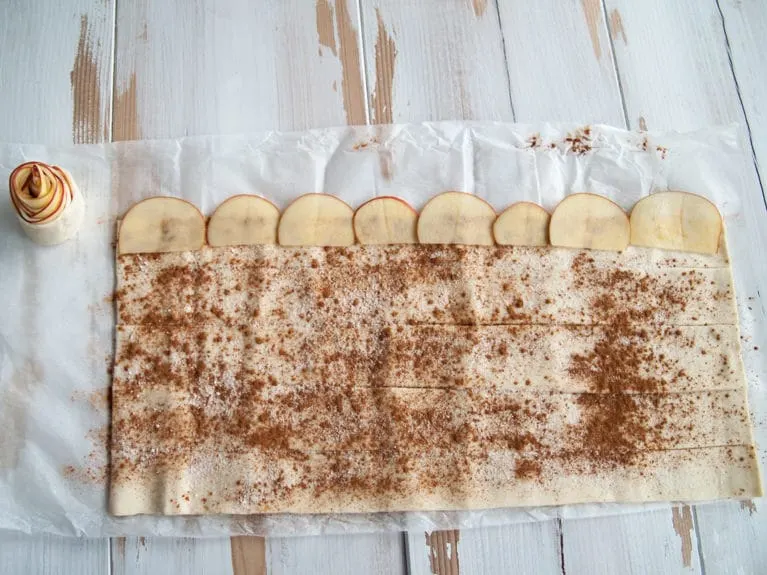 Vegan Apple Roses Puff Pastry sprinkled with cinnamon and sugar, topped with apple slices to make Vegan Apple Roses