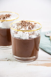 Vegan Chocolate Pudding topped with whipped cream and shaved chocolate