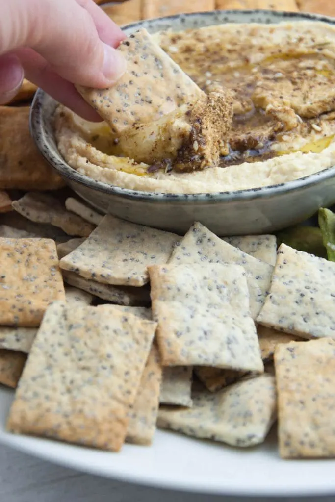 Vegan Poppy Seed Crackers dipped into Za'atar Hummus