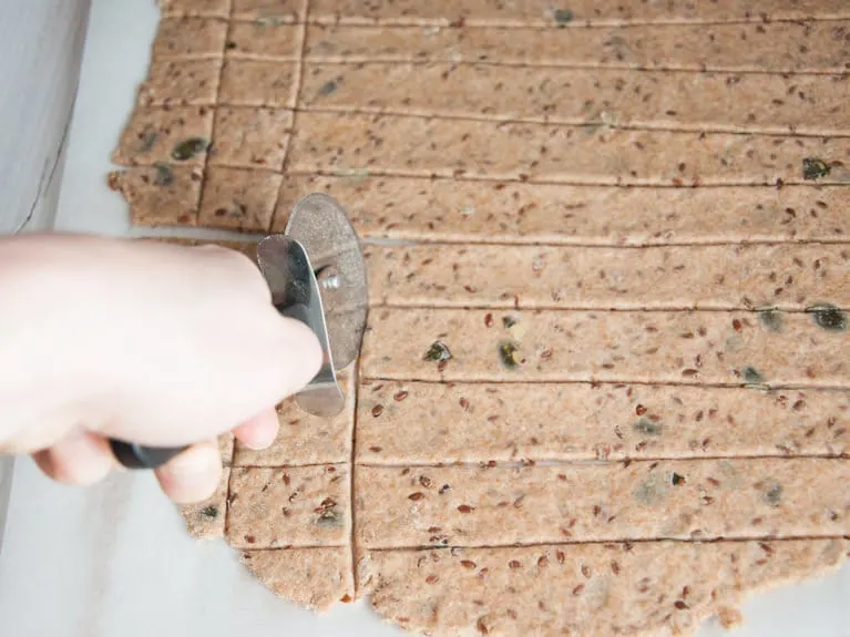 Cutting Whole Wheat Seed Crackers with a pizza cutter