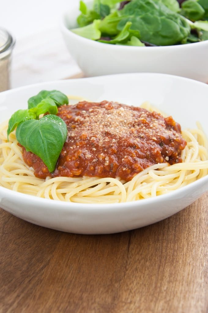 Spaghetti with vegan bolognese sauce, cashew parmesan and fresh basil