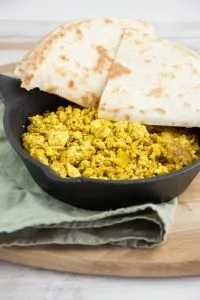 tofu scramble in a pan served with tortillas