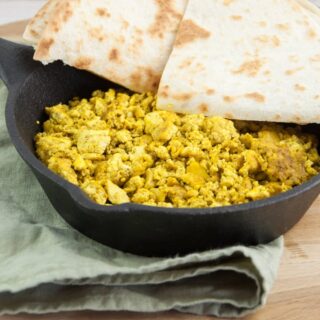 tofu scramble in a pan served with tortillas