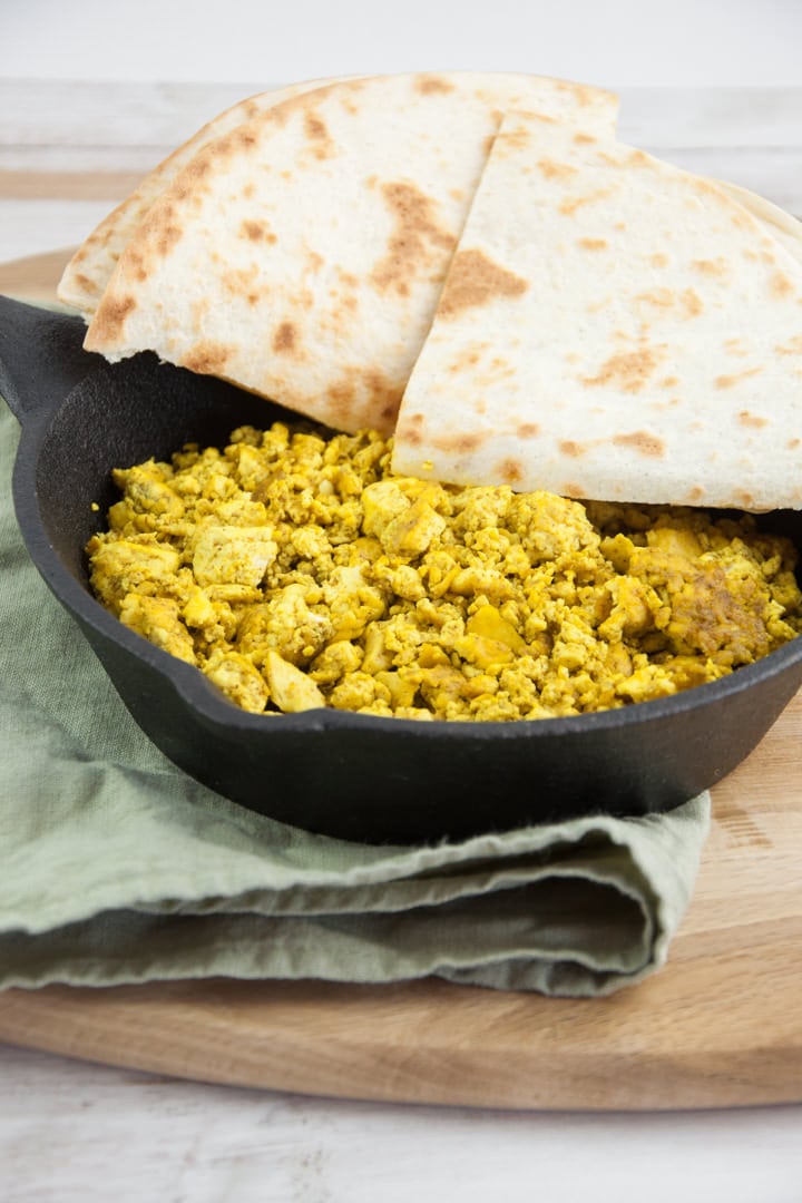 tofu scramble in a pan served with tortillas