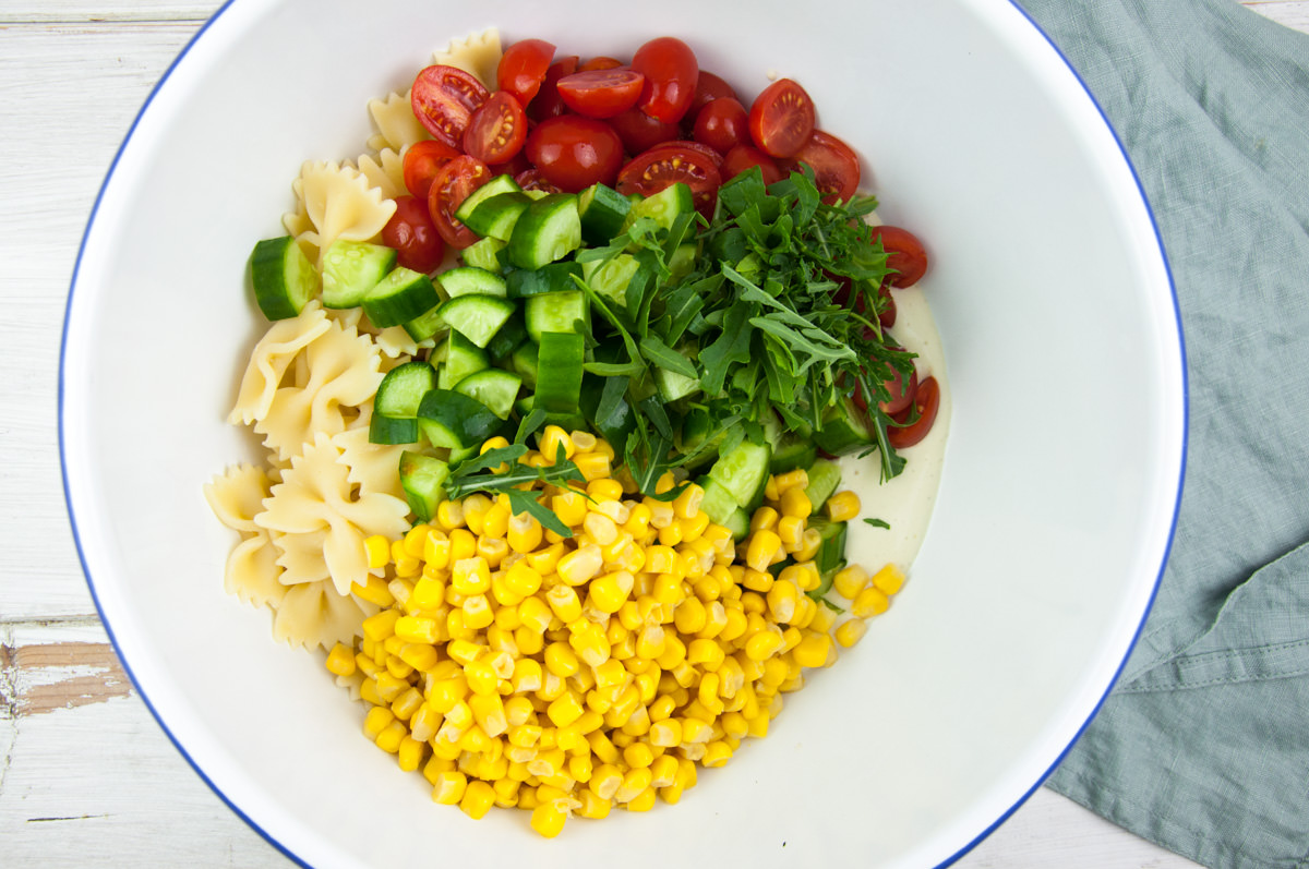 pasta, tomatoes, cucumber, corn in a bowl