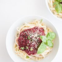 Fruity & Purple Spaghetti Bolognese topped with cashew parmesan and fresh basil