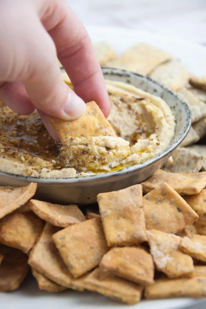 Vegan Pizza Crackers dipped into hummus