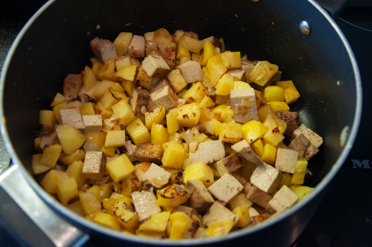 onions, garlic, smoked tofu and potato cubes in a pot