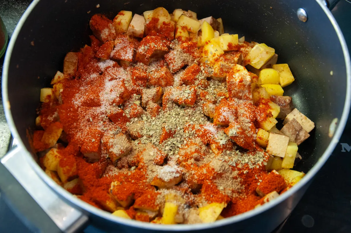 smoked tofu, potatoes, paprika powder, ground caraway, marjoram, and salt in a pot