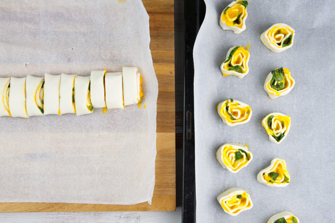 Sliced pinwheels on the left and pinwheels on a baking tray