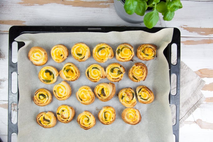 pumpkin basil pinwheels on a baking tray after baking