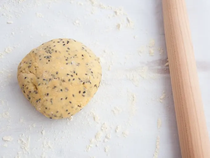 Gluten-free Vegan Chickpea Crackers Dough with a rolling pin