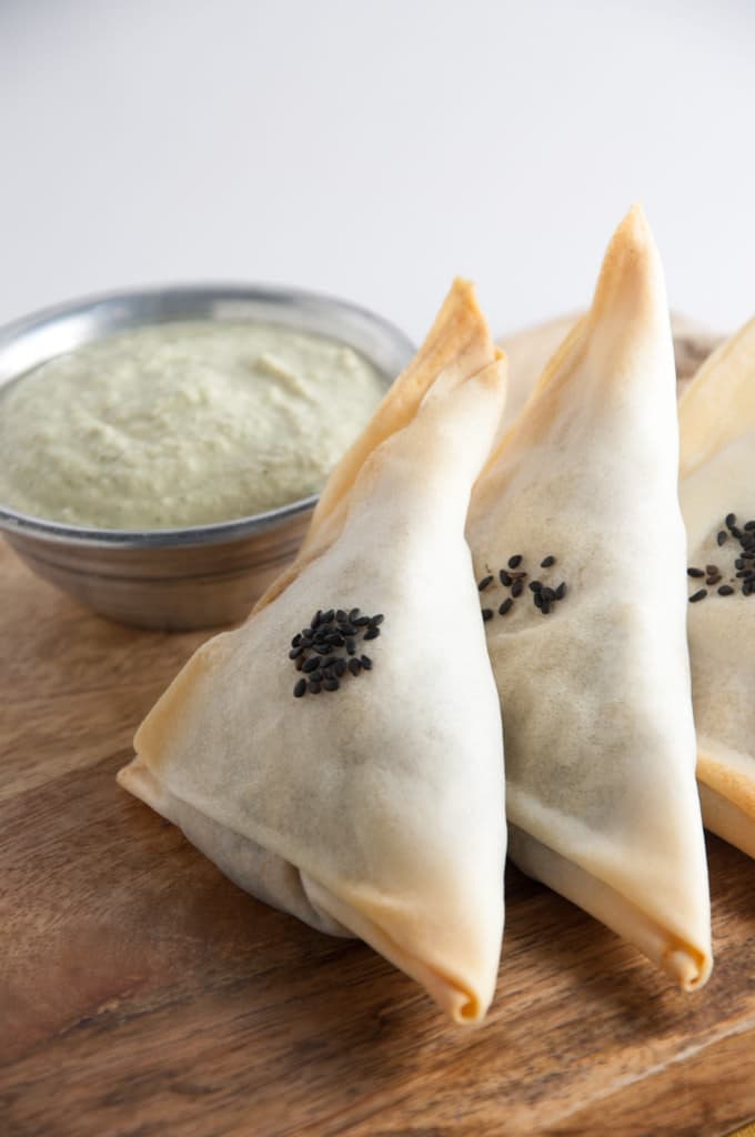Baked Samosas filled with spinach & potatoes served with a cilantro sunflower seed sauce