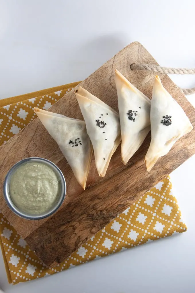 Baked Samosas filled with spinach & potatoes served with a cilantro sunflower seed sauce