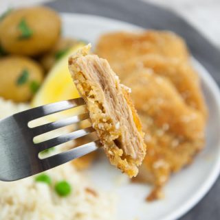 vegan schnitzel served with rice & peas, and potatoes