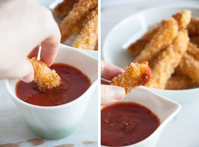 Dipping Vegan Cheese Sticks in marinara sauce