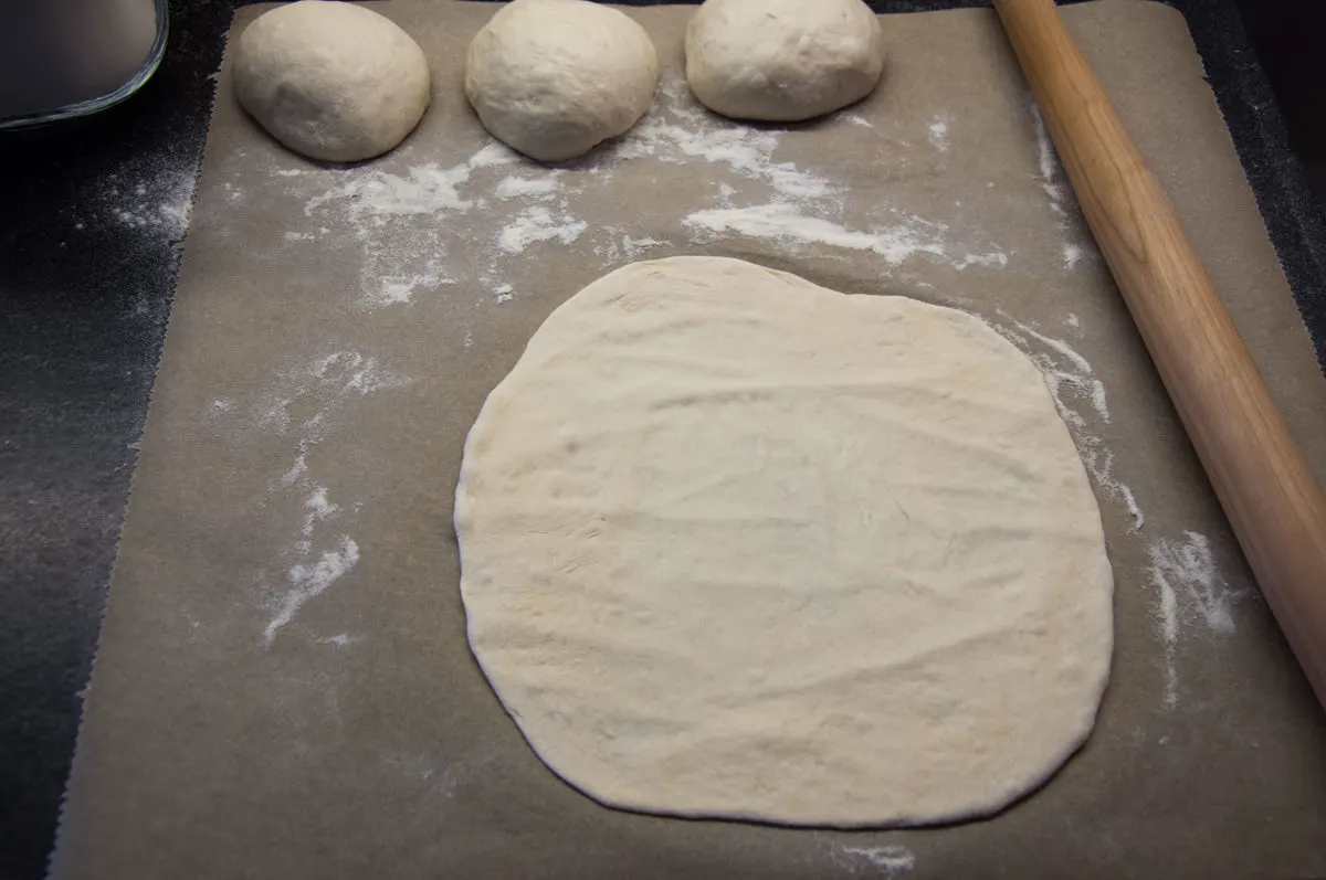 rolling out flour tortillas