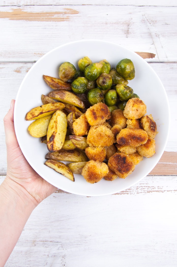 vegan pumpkin nuggets with brussels sprouts and wedges