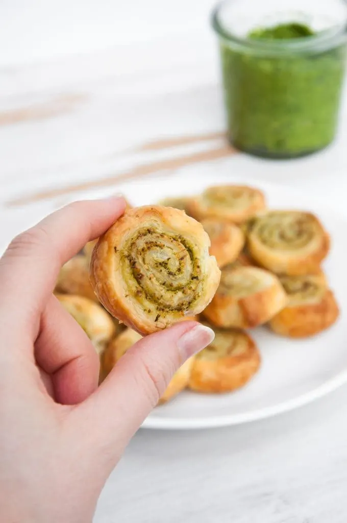 One Arugula Pesto Pinwheels being held in the hand