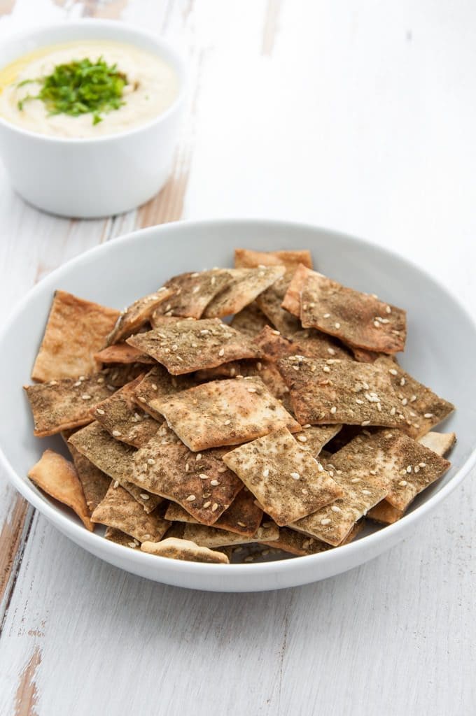 Vegan Za'atar Crackers in a bowl with hummus