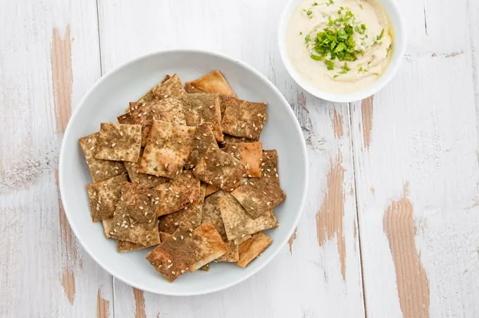 Vegan Za'atar Crackers in a bowl with hummus