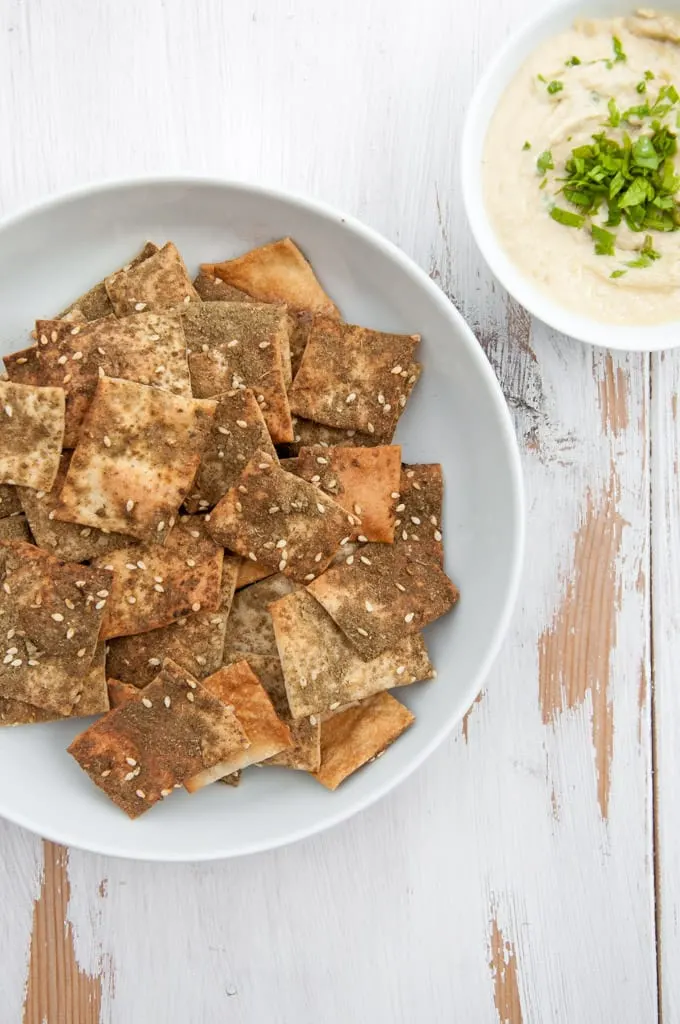 Vegan Za'atar Crackers in a bowl with hummus