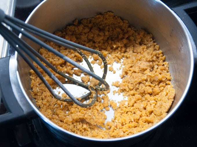 stirring nutritional yeast into spiced butter