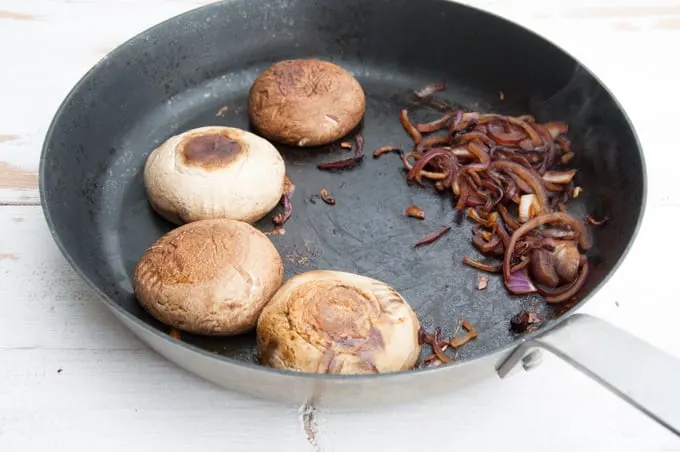 Portobello and caramelized onions in a pan