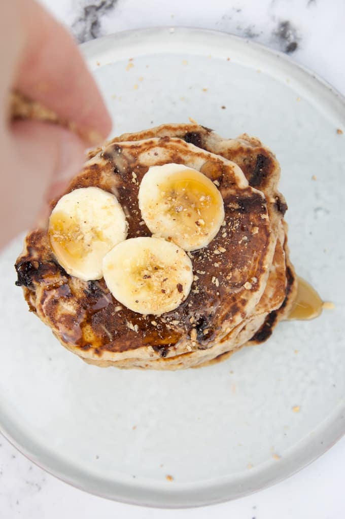 Vegan Banana Bread Pancakes with Chocolate Chunks sprinkled with hazelnut meal