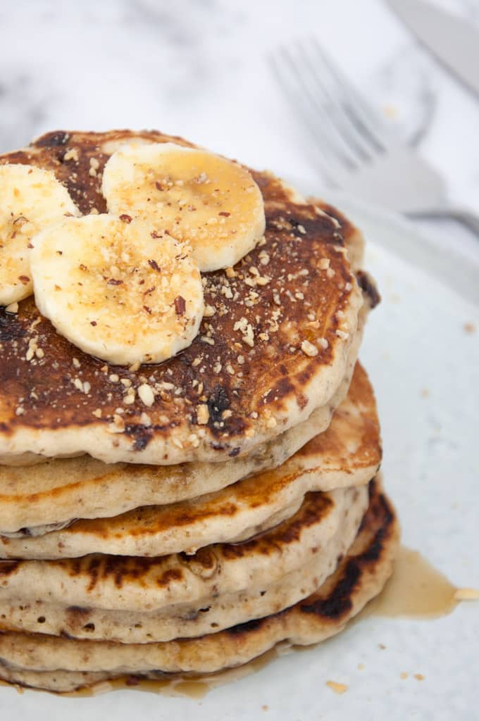 Vegan Banana Bread Pancakes with Chocolate Chunks, banana slices and hazelnut meal