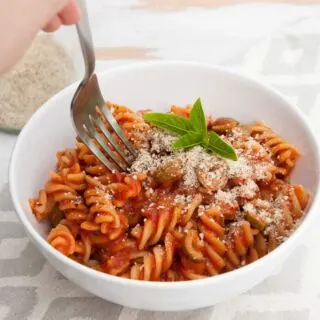 A fork digging into Tomato Olive Pasta