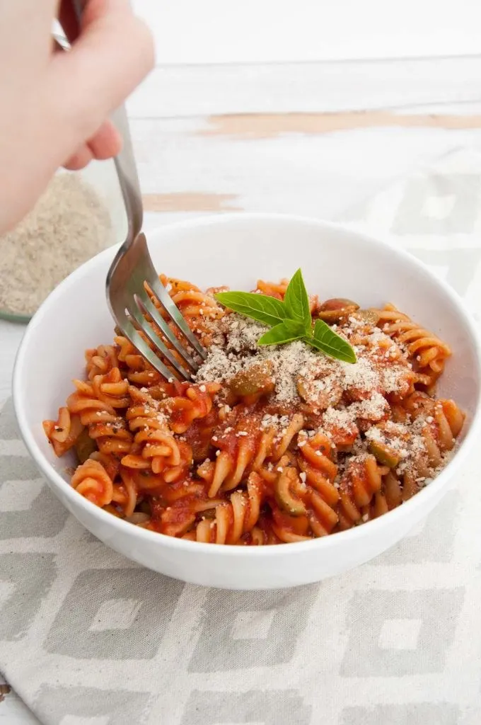 A fork digging into Tomato Olive Pasta