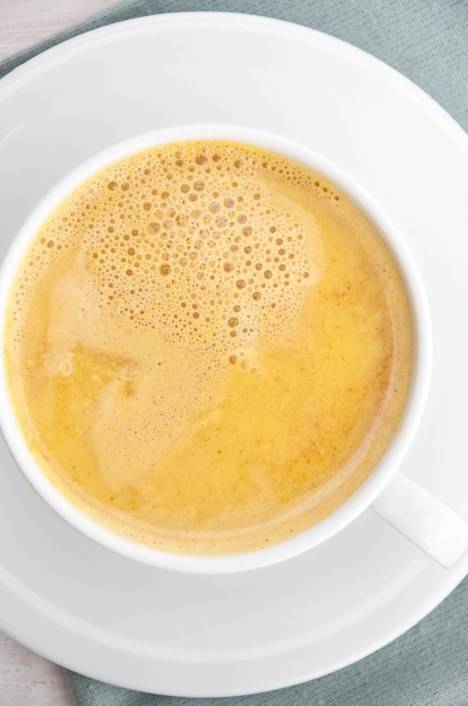 Golden Milk with turmeric and cinnamon in a cup