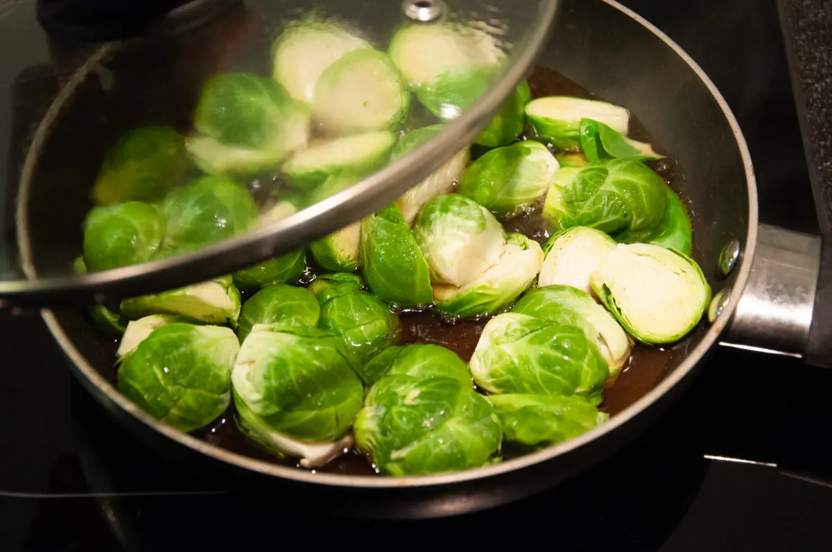 Brussels sprouts in pan with water and soy sauce