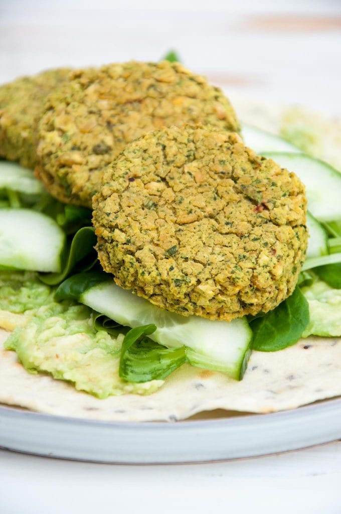 Spinach Falafel, cucumber, salad and mashed avocado on a tortilla