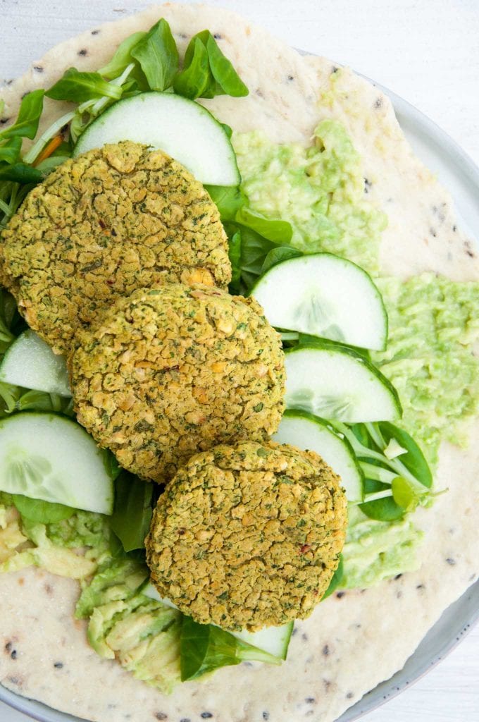 Spinach Falafel, cucumber, salad and mashed avocado on a tortilla