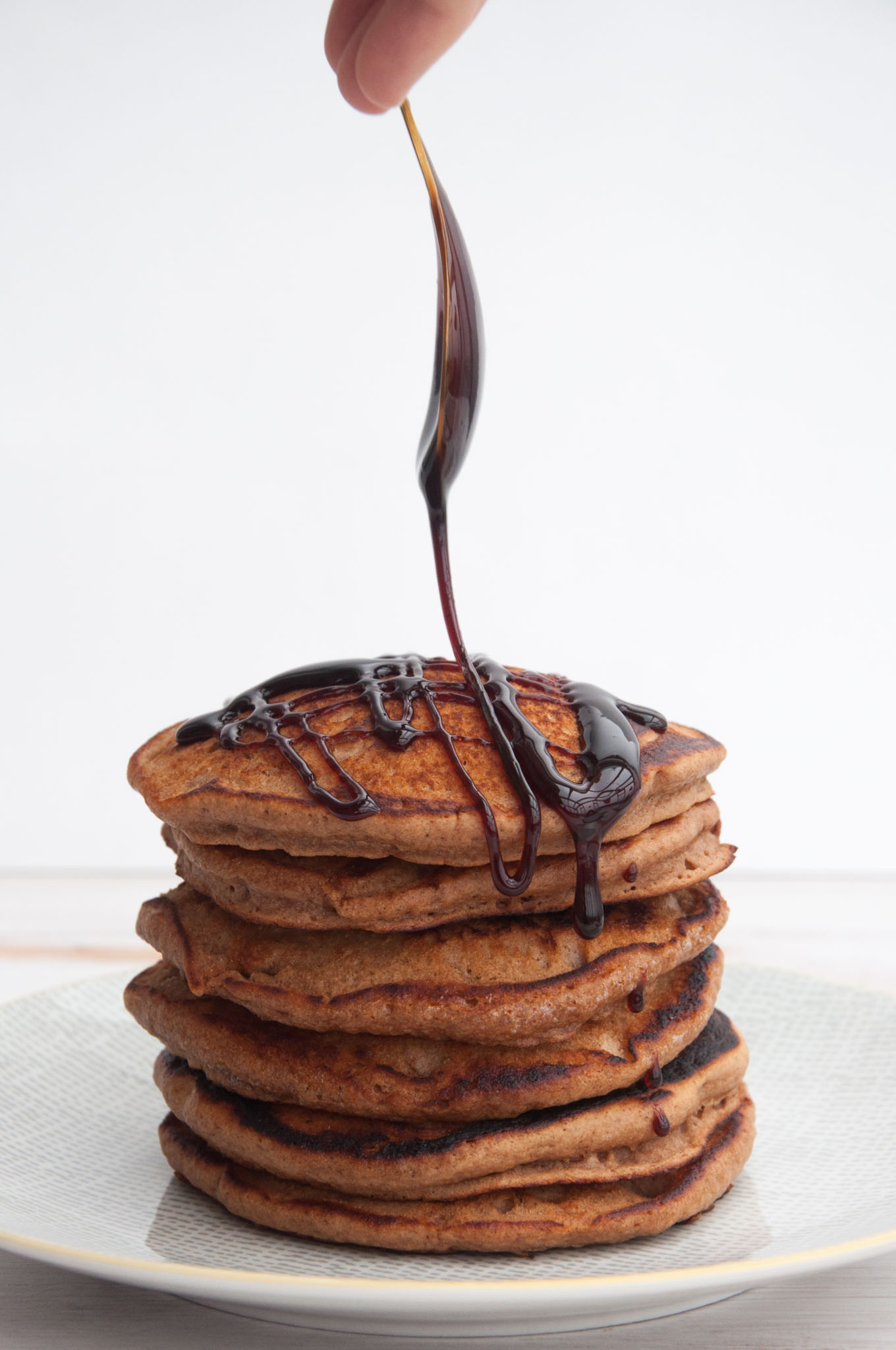 Vegan Gingerbread Pancakes drizzled with date syrup