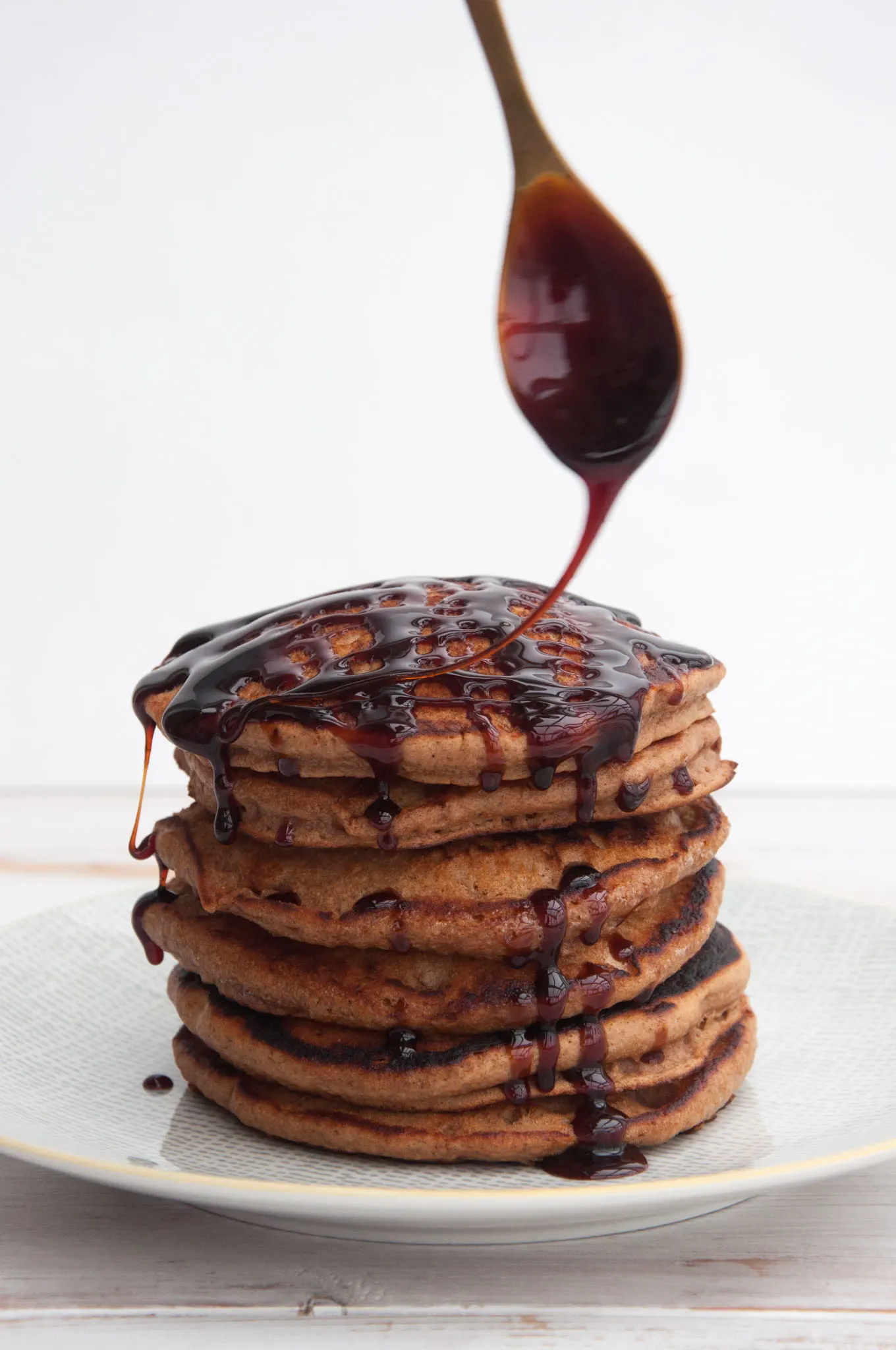 Vegan Gingerbread Pancakes drizzled with date syrup