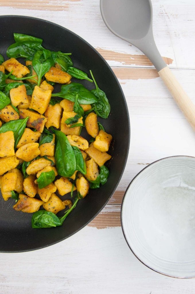 Crispy Pumpkin Gnocchi with spinach in pan