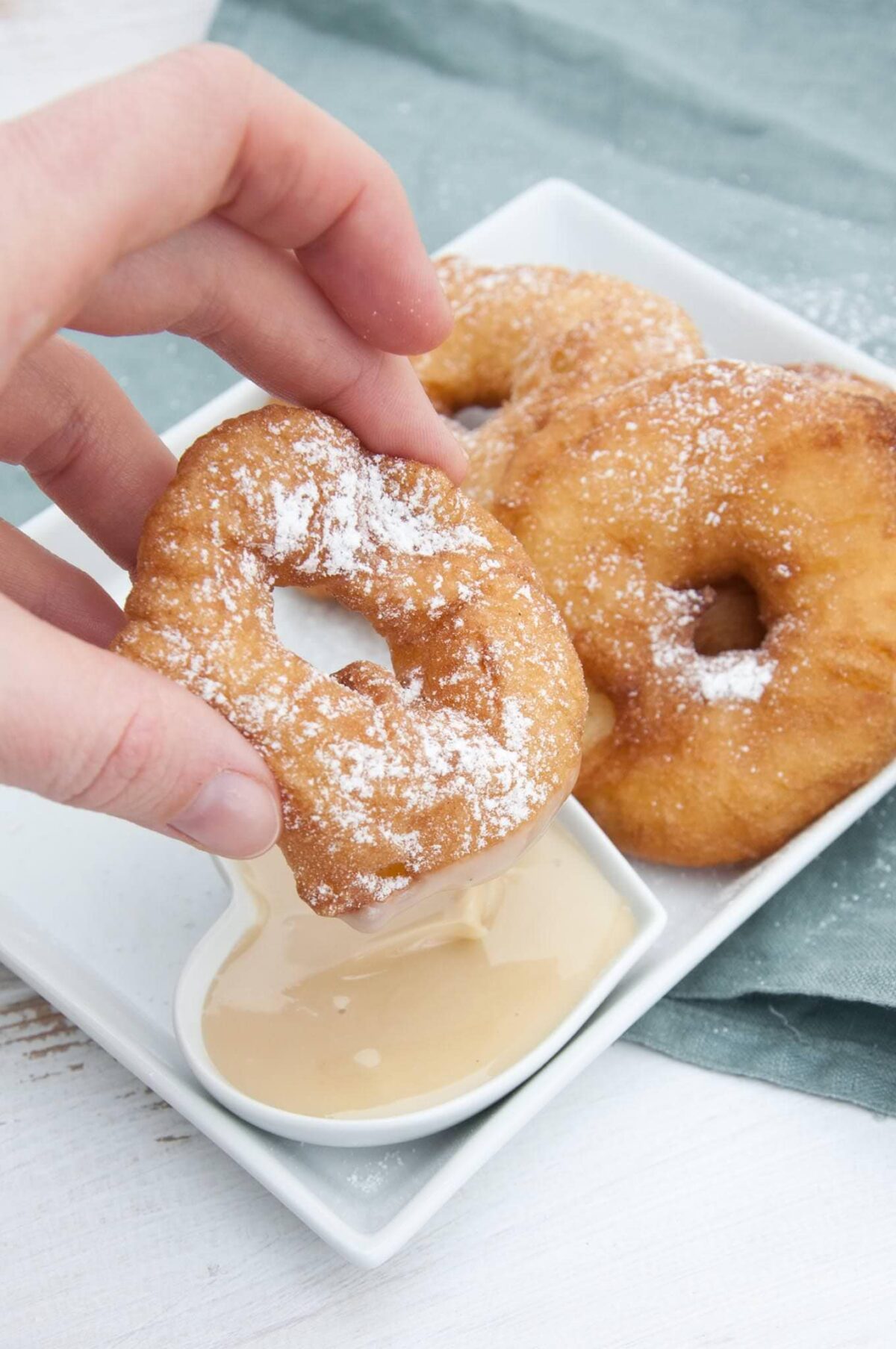 Vegan Apple Fritter Rings dipped in almond maple sauce