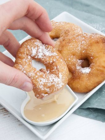 Vegan Apple Fritter Rings dipped in almond maple sauce
