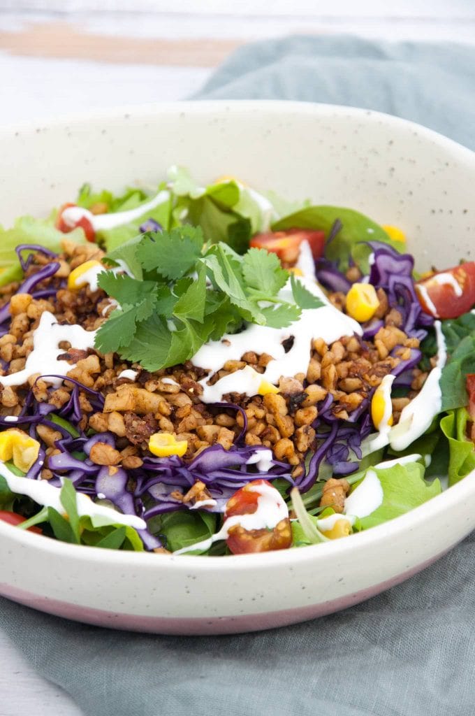 Vegan Taco Salad Bowl with Walnut Meat, corn, cabbage, tomatoes, mayo and cilantro