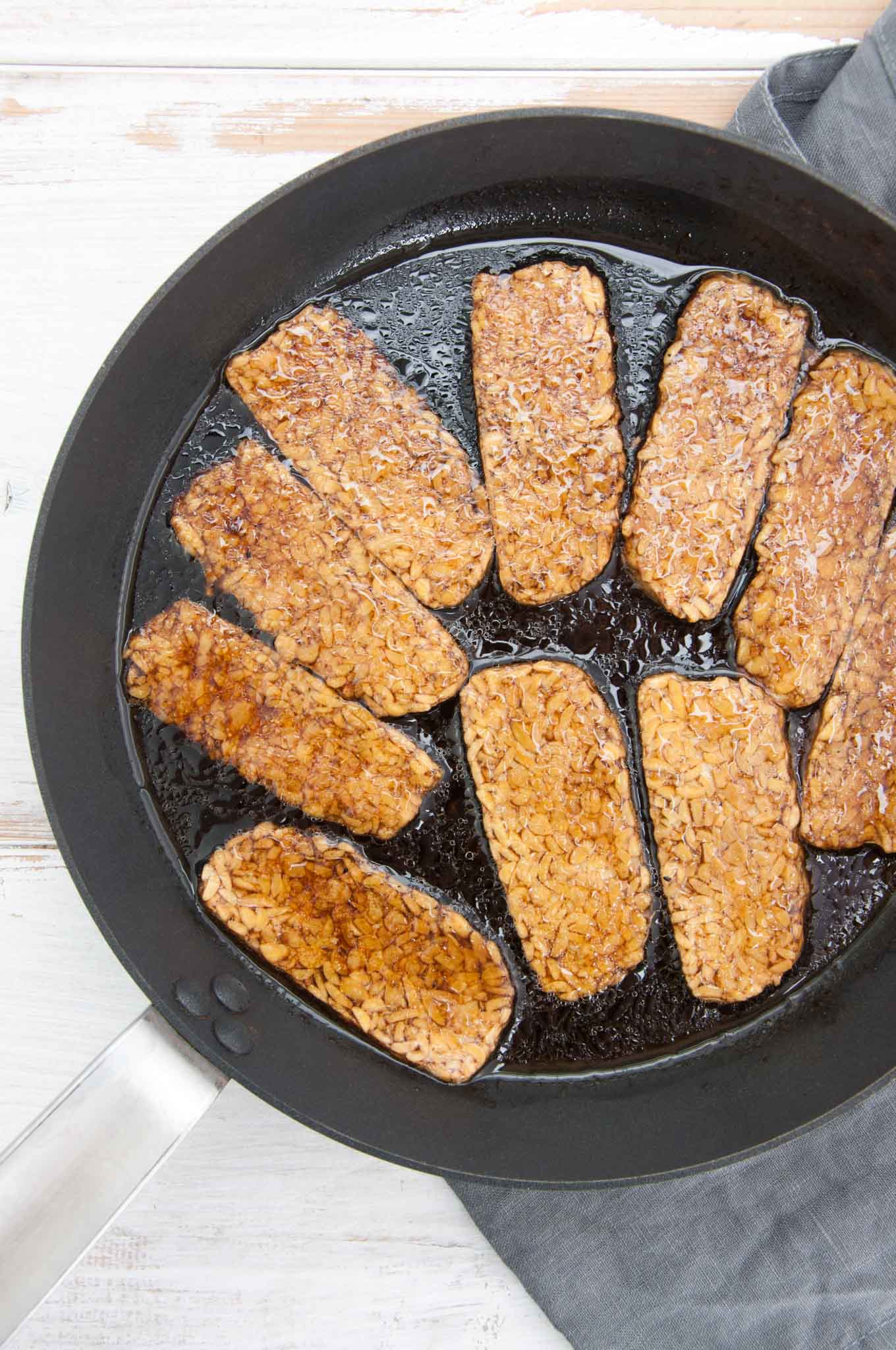 Vegan tempeh bacon drenched in a smoky marinade