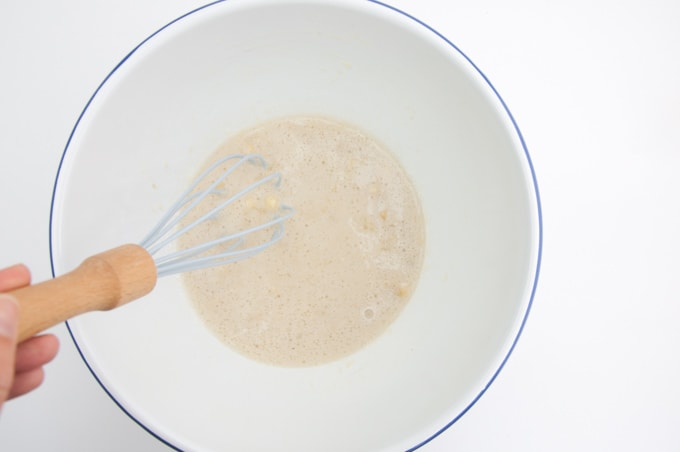 Whisking mashed banana, maple syrup, oil, and rice milk