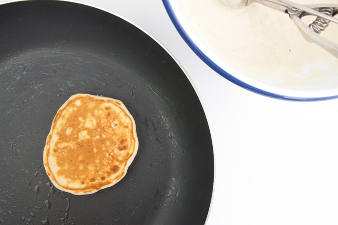A pancake in a pan that is golden on top