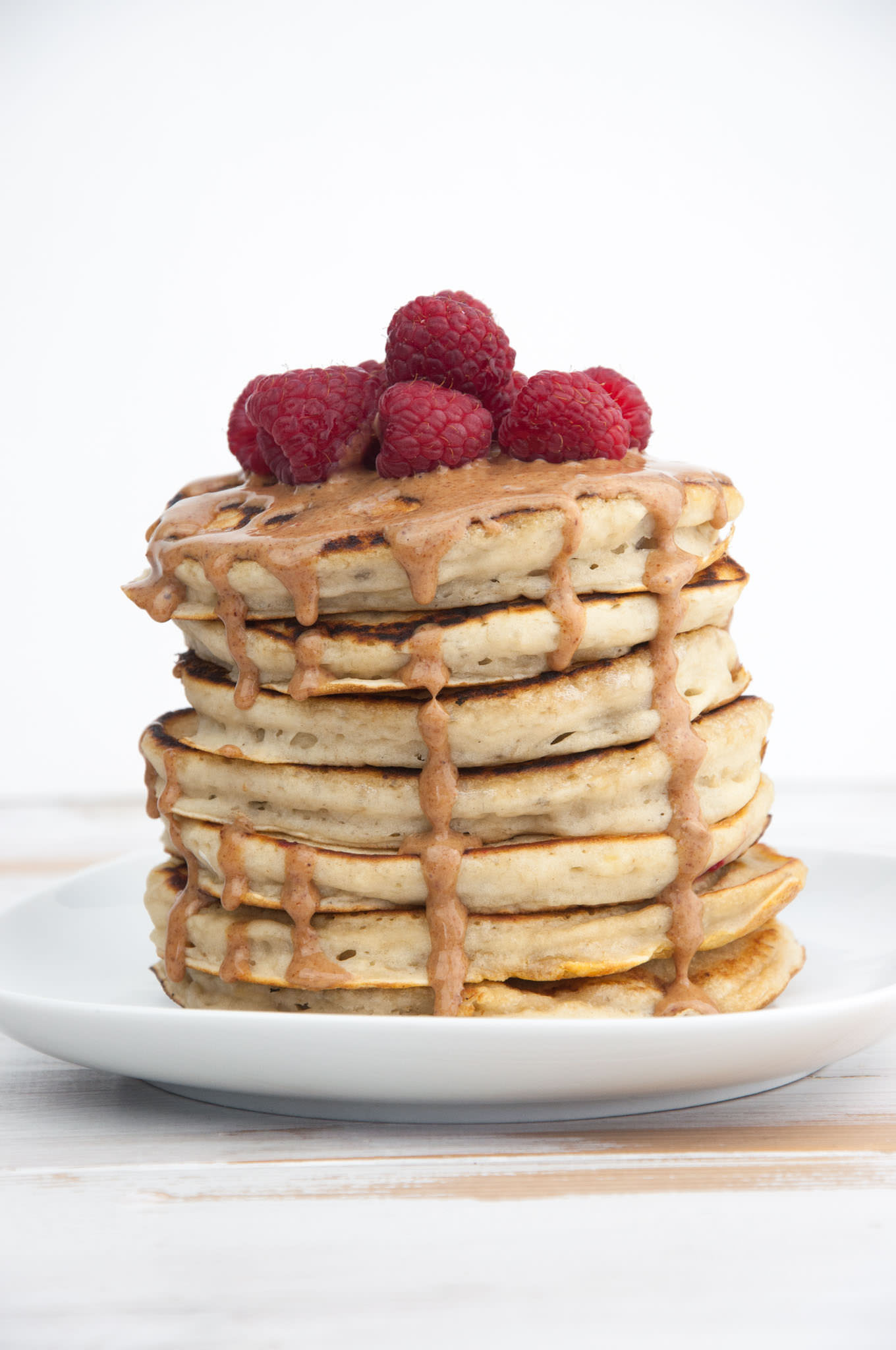 Fluffy Vegan Banana Pancakes With Almond Butter And Raspberries