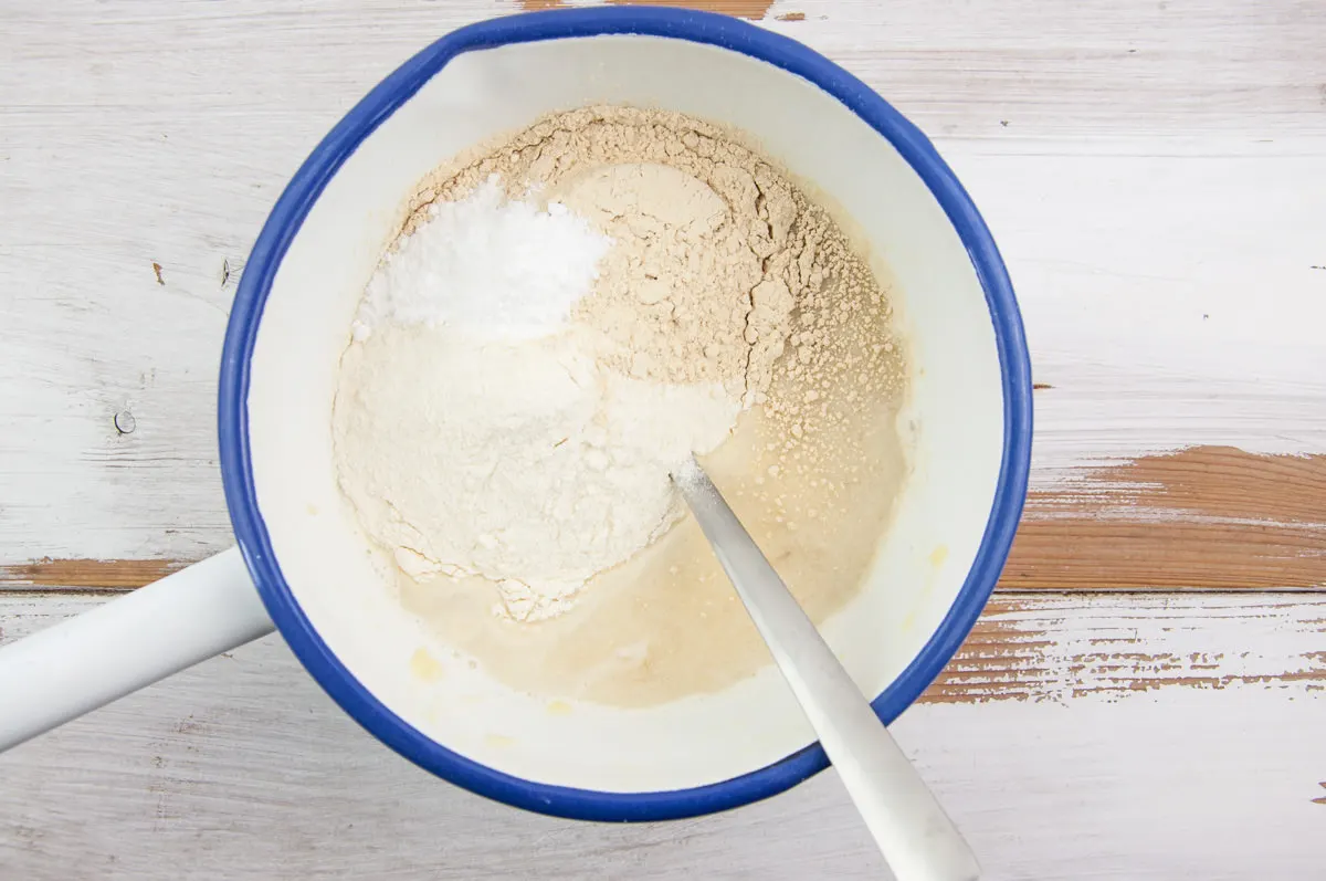 flour, protein powder, and baking powder with mashed banana and plant-based milk
