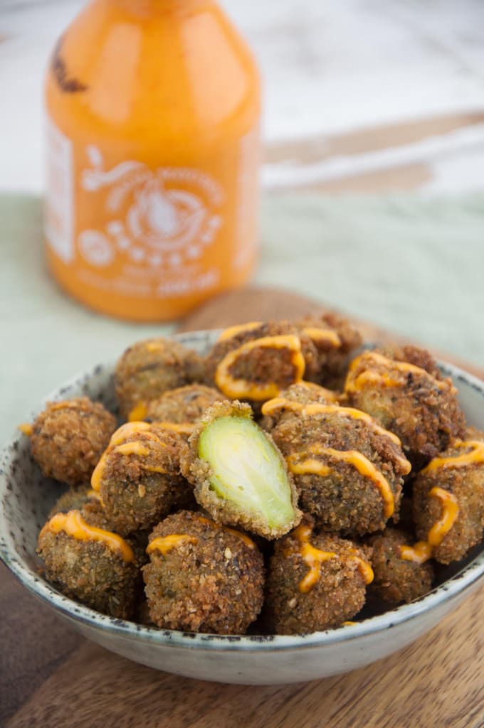 Vegetable Pakoras in a basket with mango chutney in the background